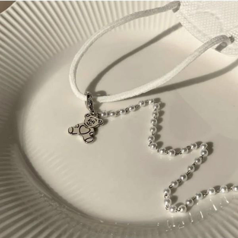 Playful pearl necklace with gold pendants Stornfield