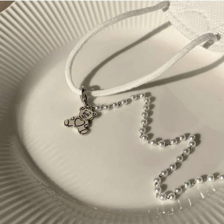 Playful pearl necklace with gold pendants Stornfield