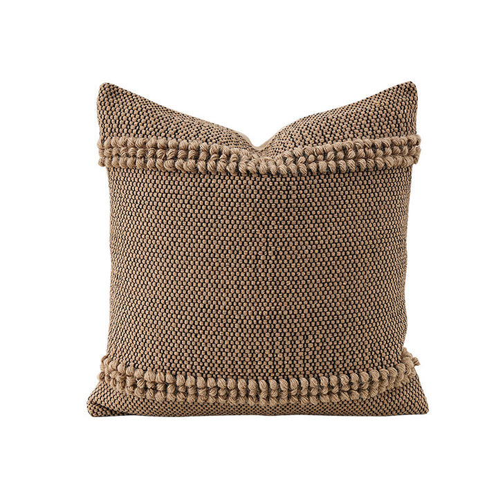 Square Boho decorative cushion made of coarsely woven cotton blend with decorative cord tufts