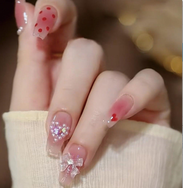 Artistic Nail Art with Glitter and Flower Applications Stornfield