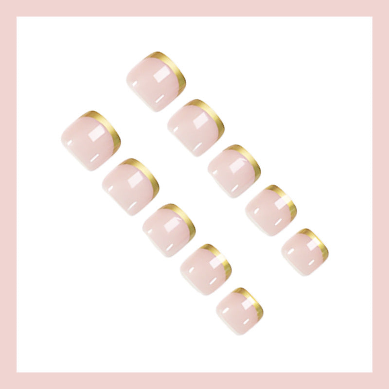 Toenail art set with elegant gold tips and delicate embellishments Stornfield