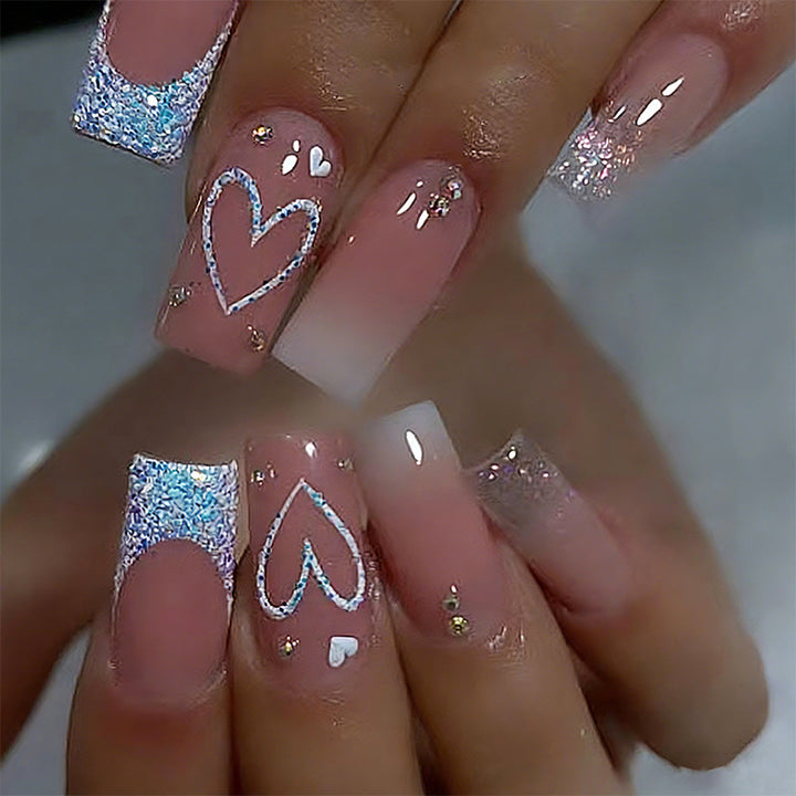 Artificial nails with sparkling heart designs and glitter details Stornfield