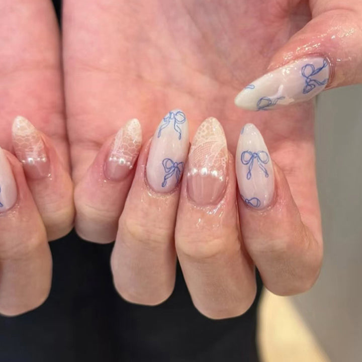 Artistic stiletto nails with delicate bow decorations Stornfield