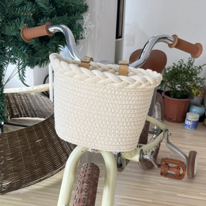 braided rope bike basket with pom pom embellishments and leather handlebar straps Stornfield