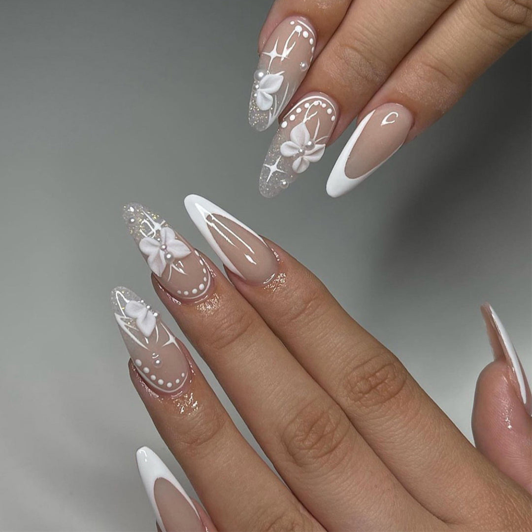 Artful stiletto nails with floral designs and glitter accents Stornfield