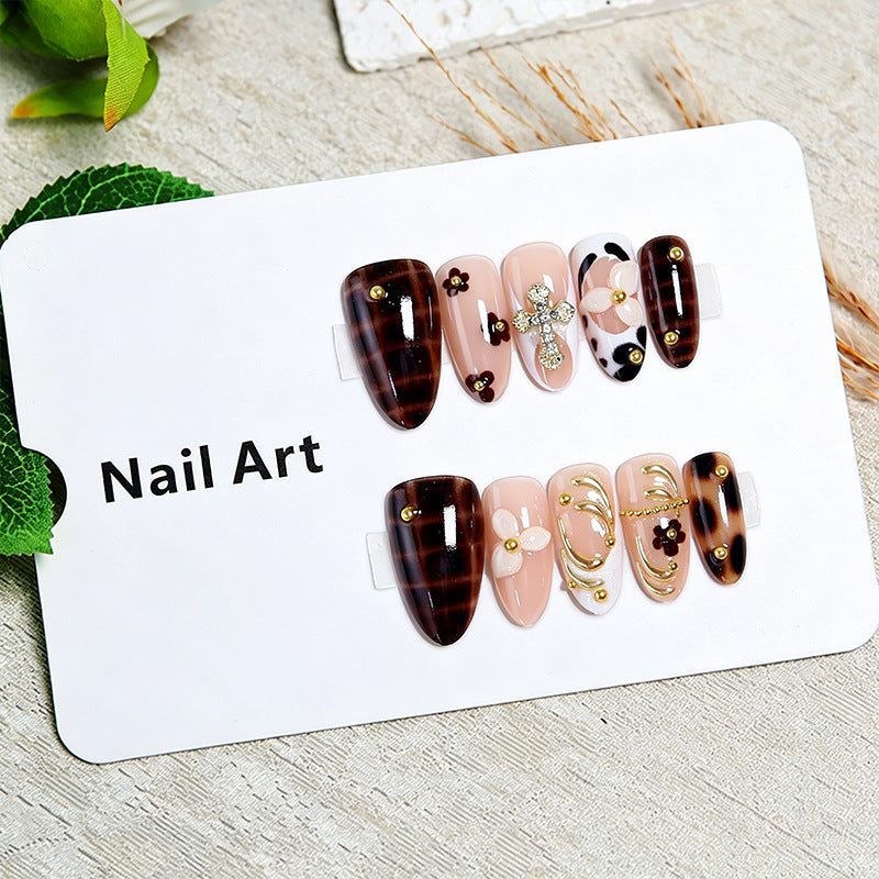 Artificial nails set with elegant gold accents and floral embellishments Stornfield