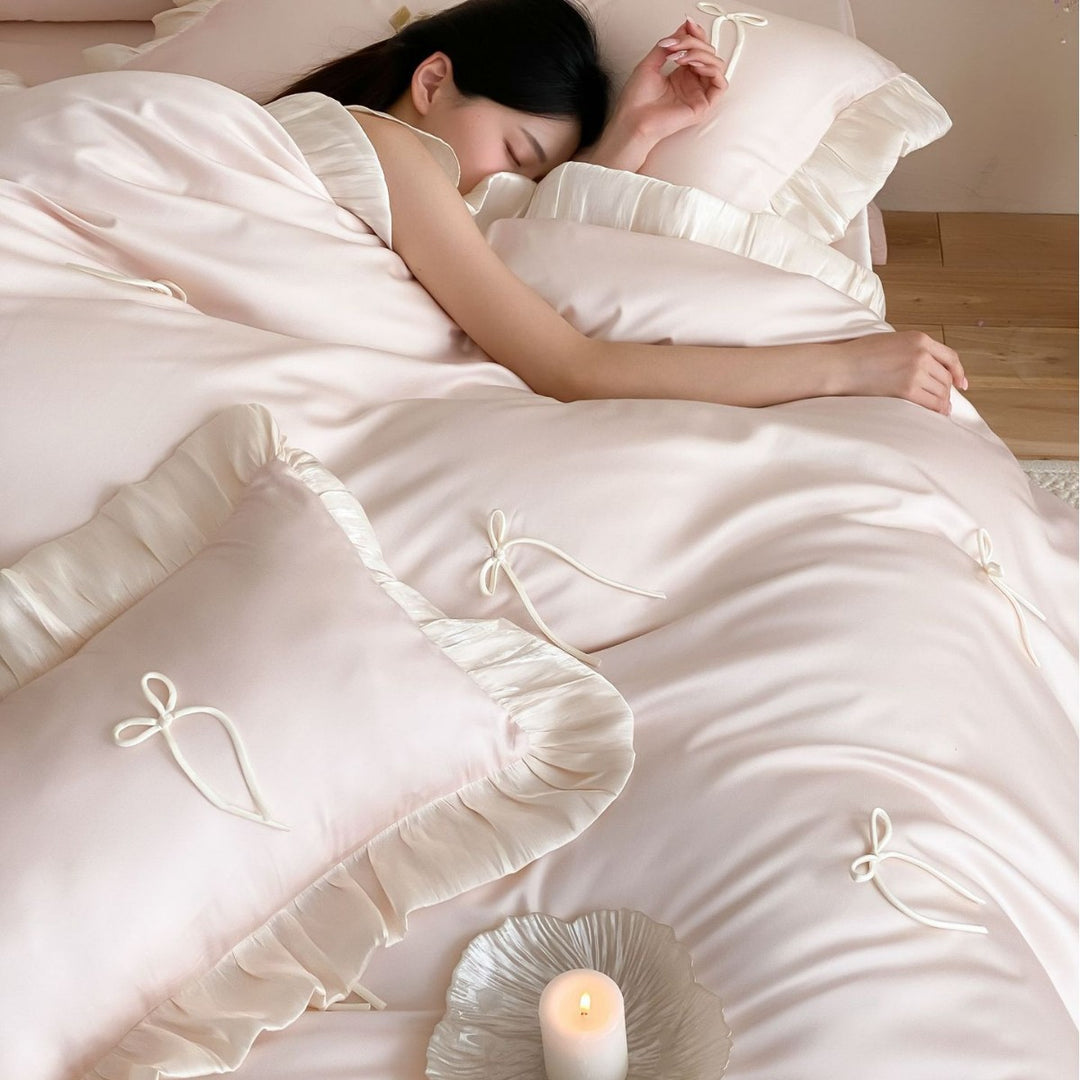Satin bedding set with ruffle edges, delicate bow appliqué and pillowcases
