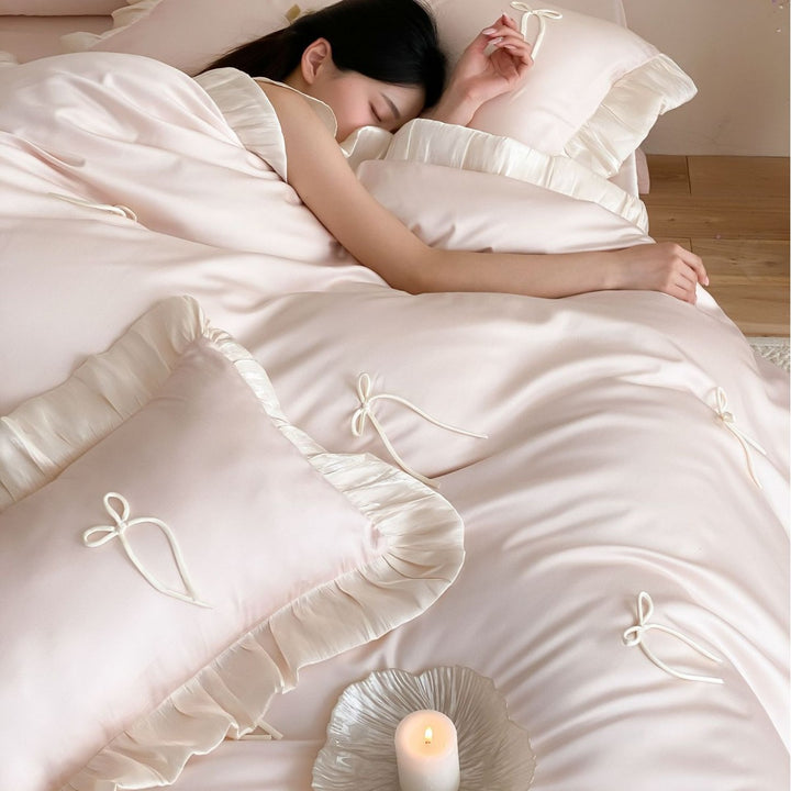 Satin bedding set with ruffle edges, delicate bow appliqué and pillowcases