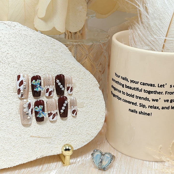 Artificial nails with glamorous rhinestone and bow design Stornfield