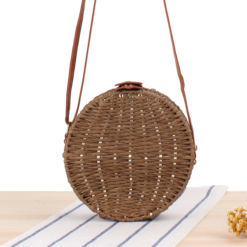Round basket bag with leather accents Stornfield