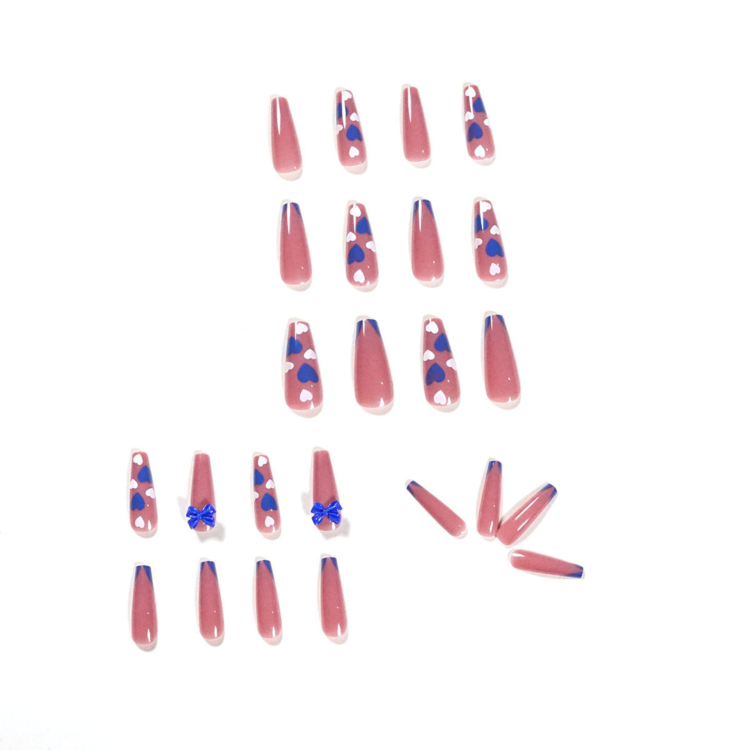 Artful stiletto nails with modern heart and bow motifs Stornfield