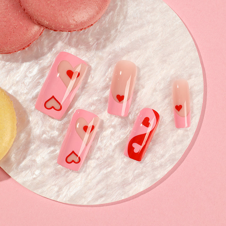 Artificial nail art with heart design and glitter accents Stornfield