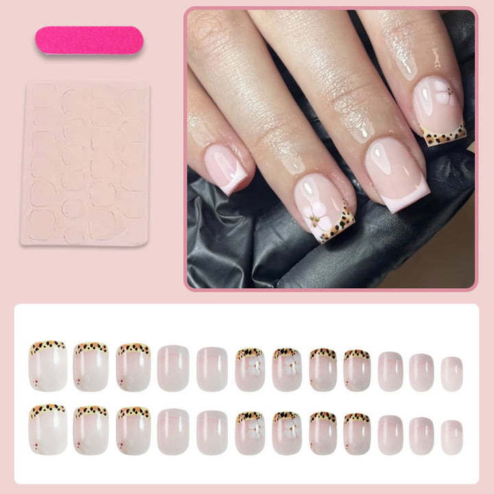 Artificial nail set with elegant French tip and floral accent Stornfield