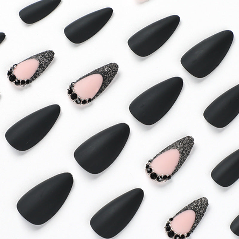Artful stiletto nails with elegant black design and glitter accents Stornfield