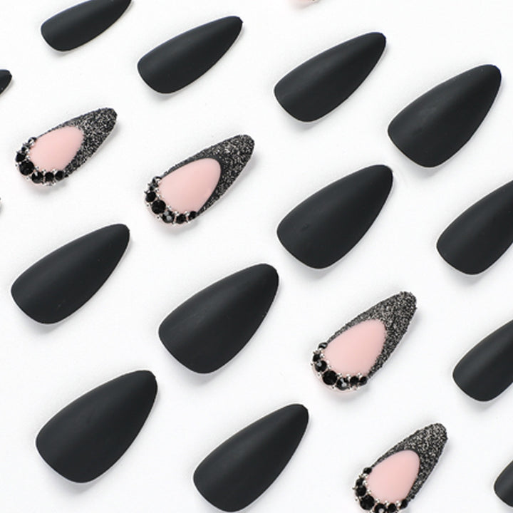 Artful stiletto nails with elegant black design and glitter accents Stornfield