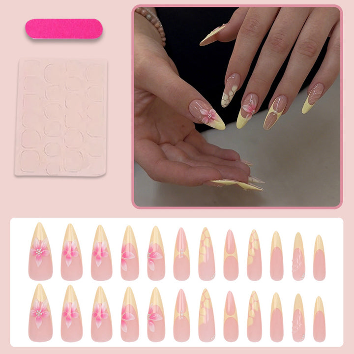 Acrylic nail set with elegant floral pattern and shimmering accents Stornfield