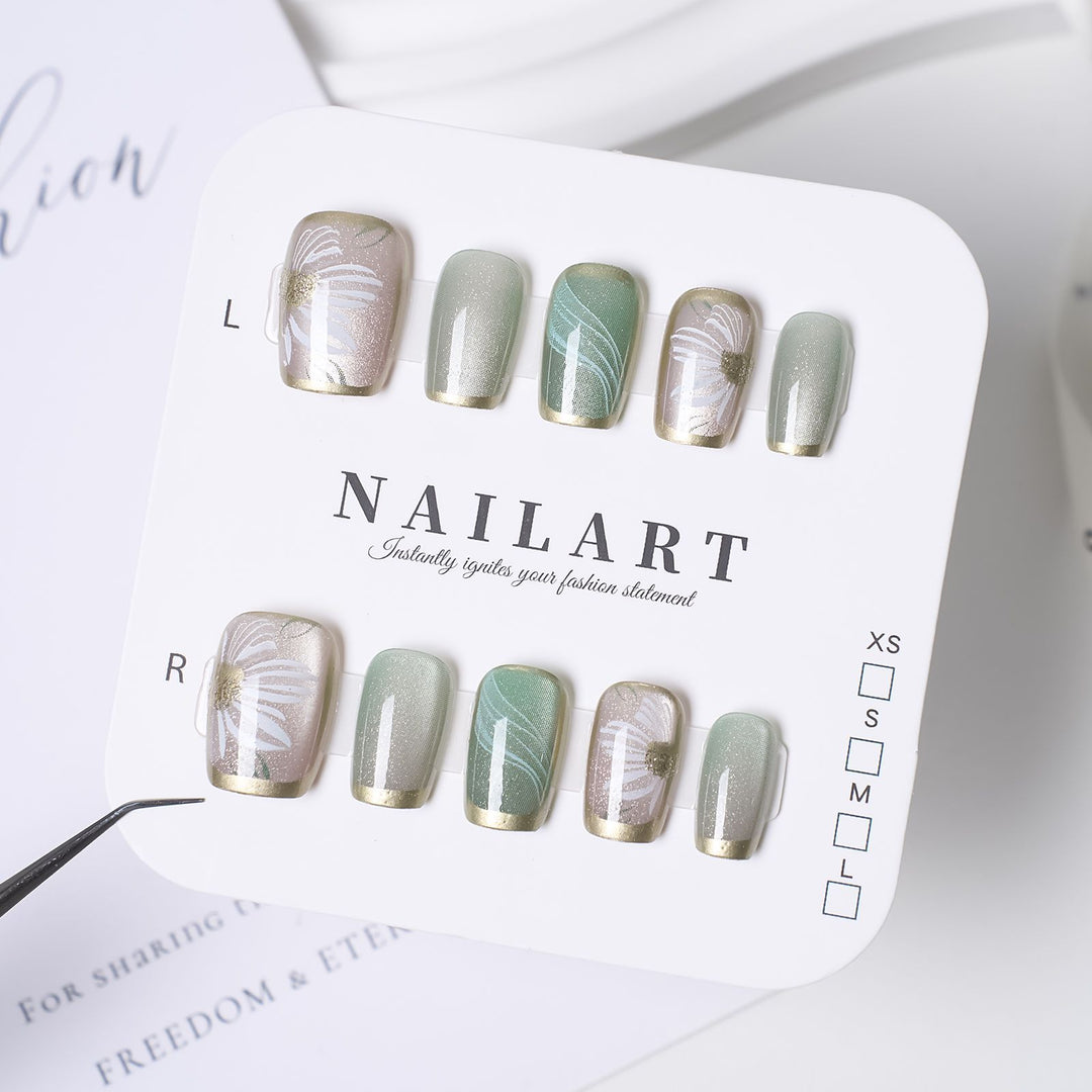 Artistic Press-On Nail Design with Floral and Glitter Accents Stornfield