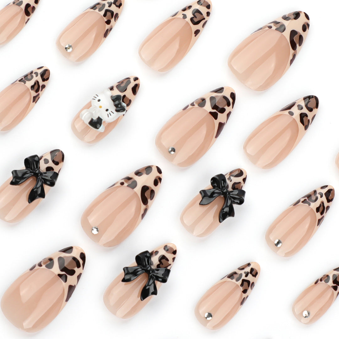 Artistic extension nails in leopard pattern with bow accents Stornfield