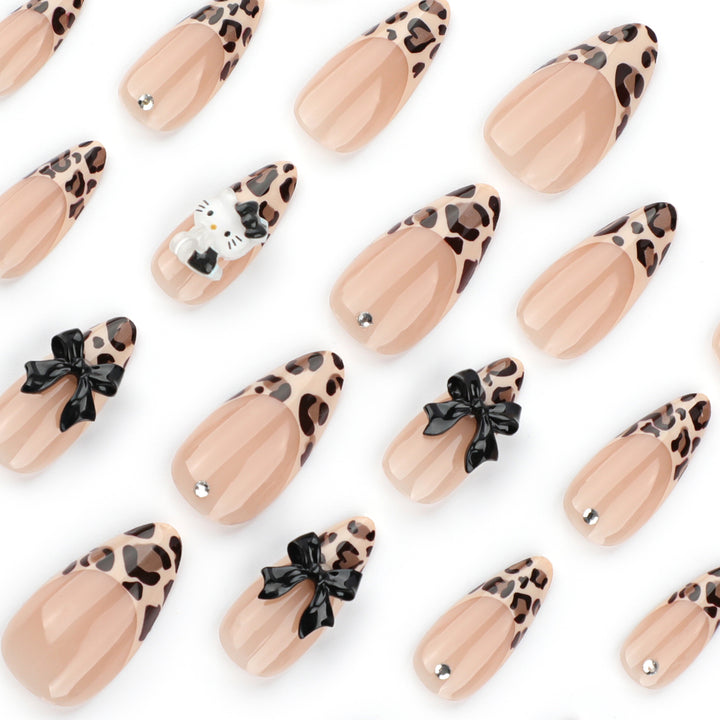 Artistic extension nails in leopard pattern with bow accents Stornfield