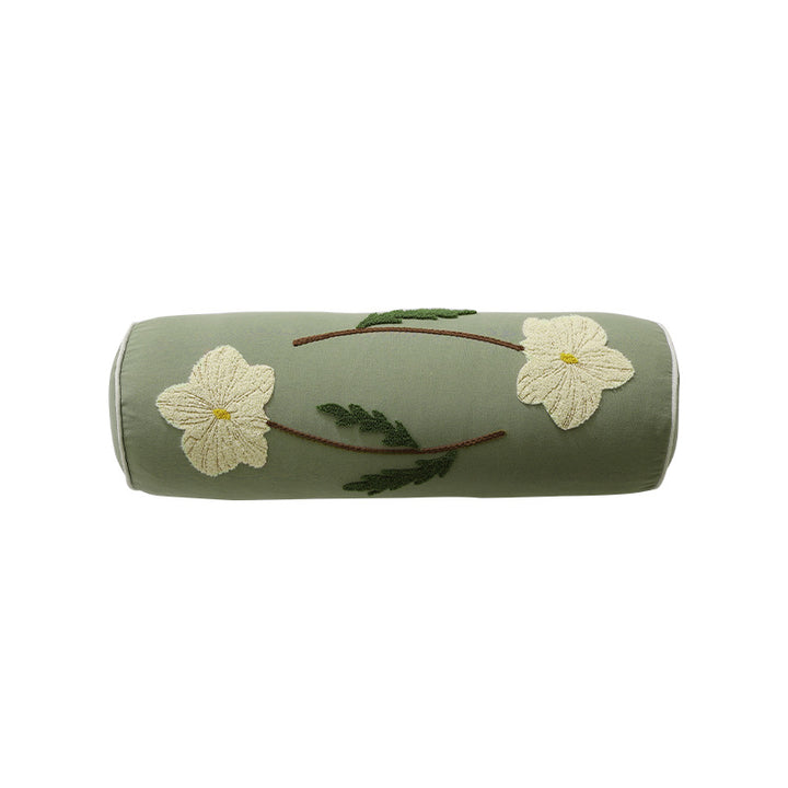 Bolster pillow with hand-stitched floral motif and decorative piping