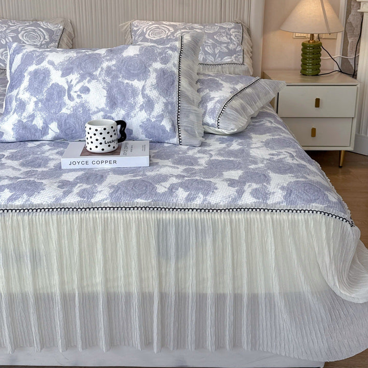 Quilted mattress and pillow set with butterfly motif and pleated bed ruffle