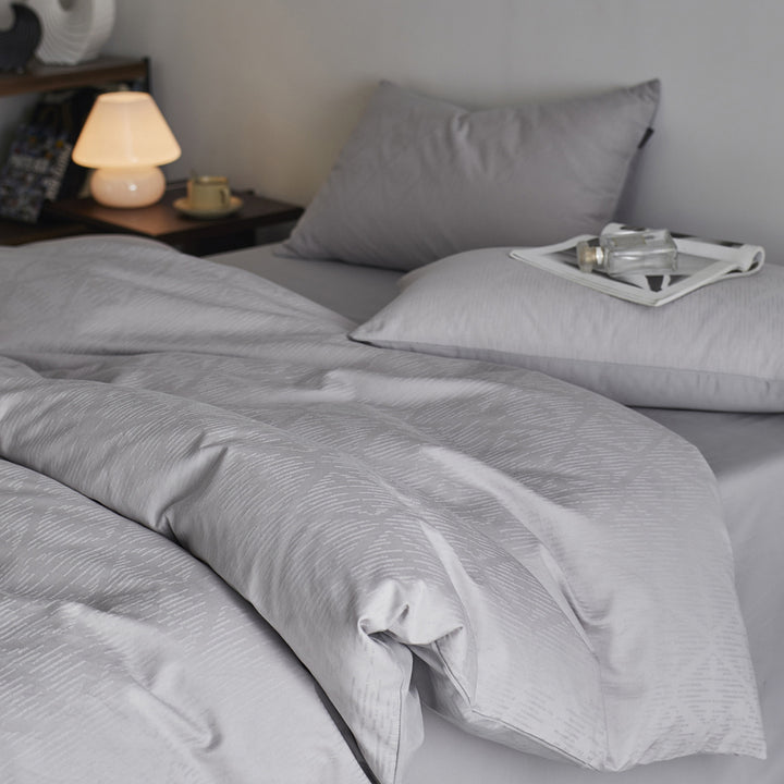 Reversible cotton percale bedding set with fine relief texture and additional pillowcases
