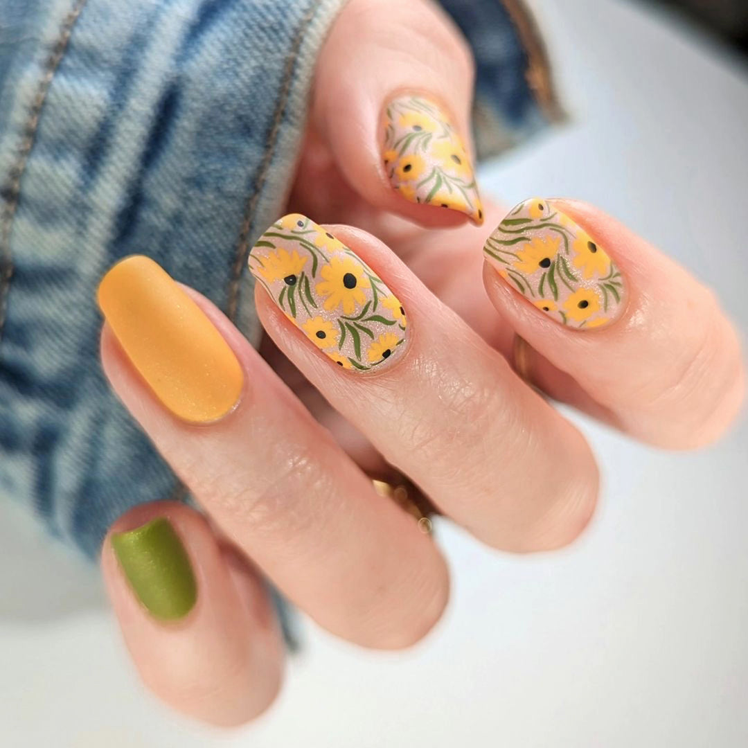 Artistic nail extensions with floral designs and creative color accents Stornfield