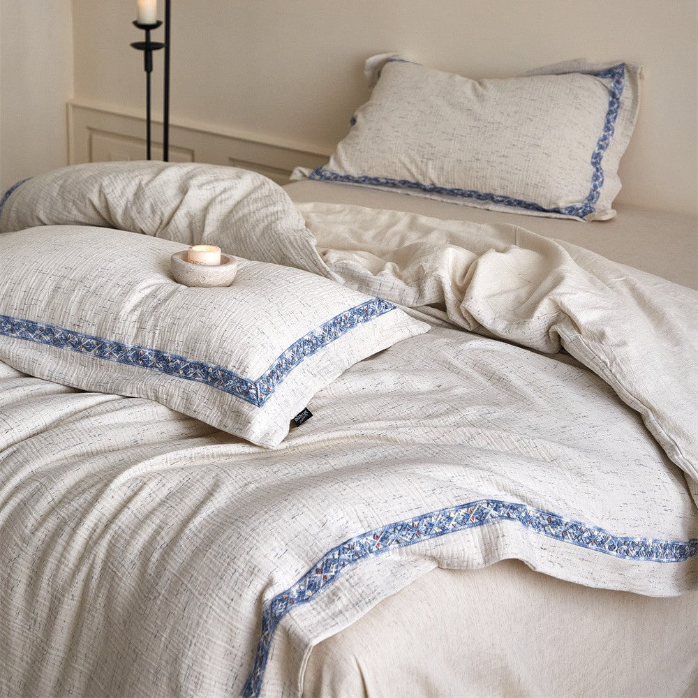 Linen bedding set with woven texture and subtle indigo border