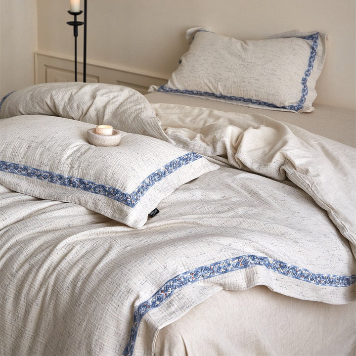 Linen bedding set with woven texture and subtle indigo border