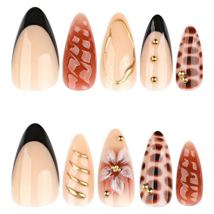 Artificial nails in modern stiletto design with golden accents Stornfield