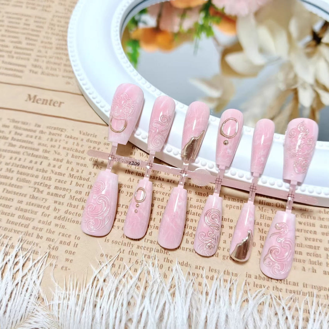 Artificial nails with elegant gold embellishments Stornfield