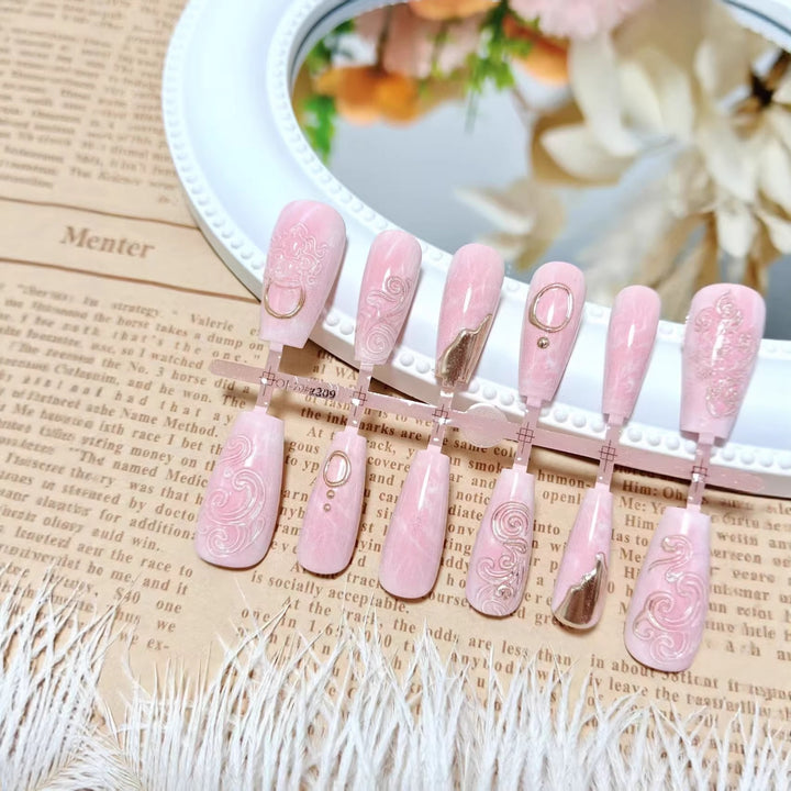 Artificial nails with elegant gold embellishments Stornfield