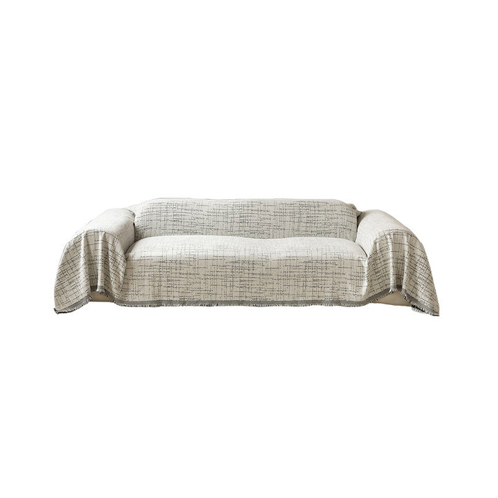Universal sofa throw made of woven cotton blend with fringes and gentle upholstery cover Stornfield