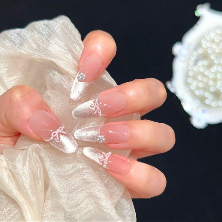 Artificial nail set with elegant bow and rhinestone embellishments Stornfield