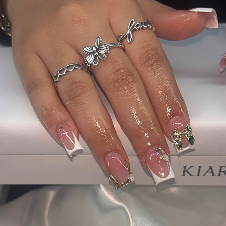 Elegant Nail Extensions with French Tips and Decorative Accents Stornfield