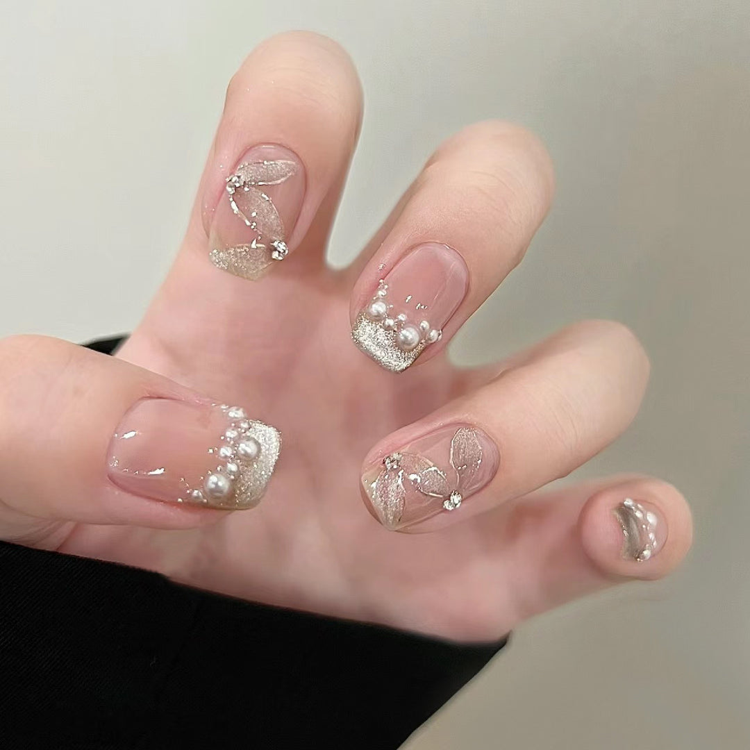 Elegant artificial nails with pearl decorations and glitter effects Stornfield