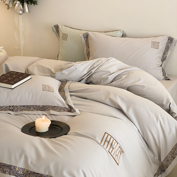 Luxurious bedding set made of cotton satin with paisley border and monogram embroidery