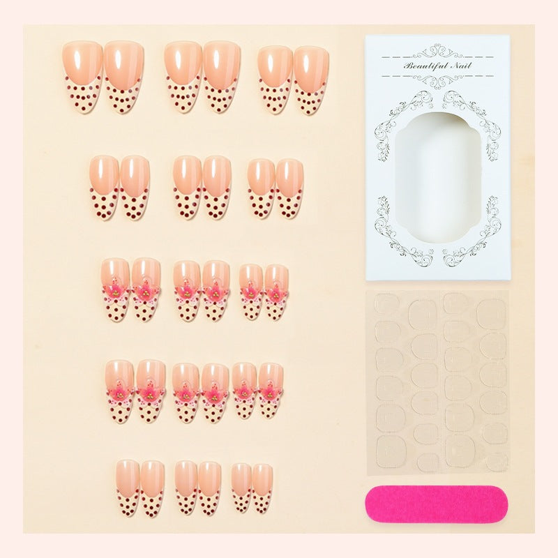 Acrylic nail set with romantic dots and floral accents Stornfield