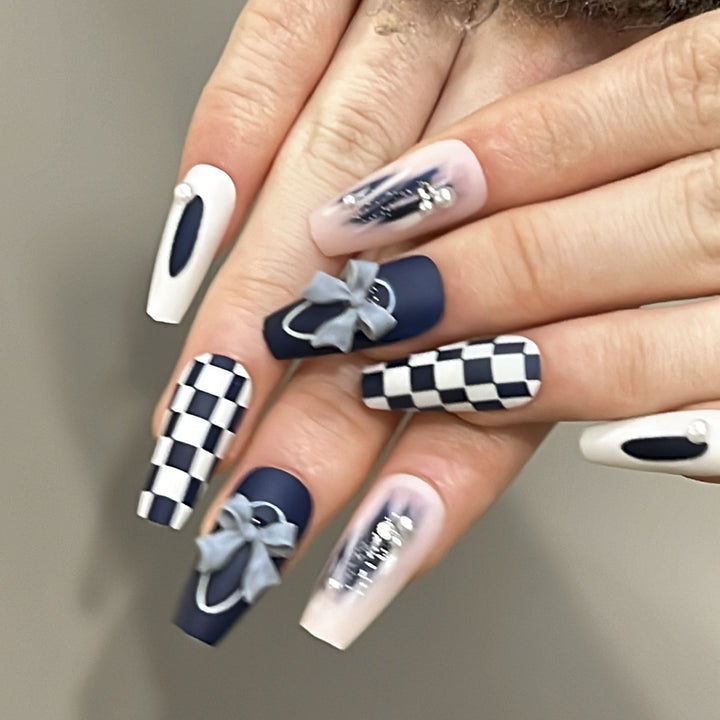 Artful nail decoration with bows and plaid pattern Stornfield