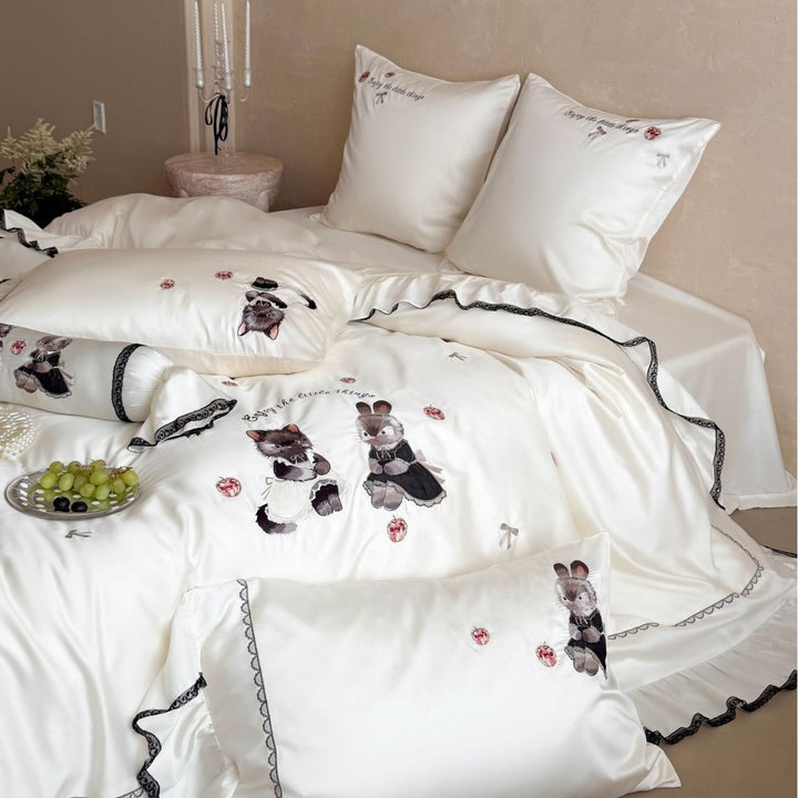 Embroidered satin bedding set with frill, ruffled hem, and animal motif