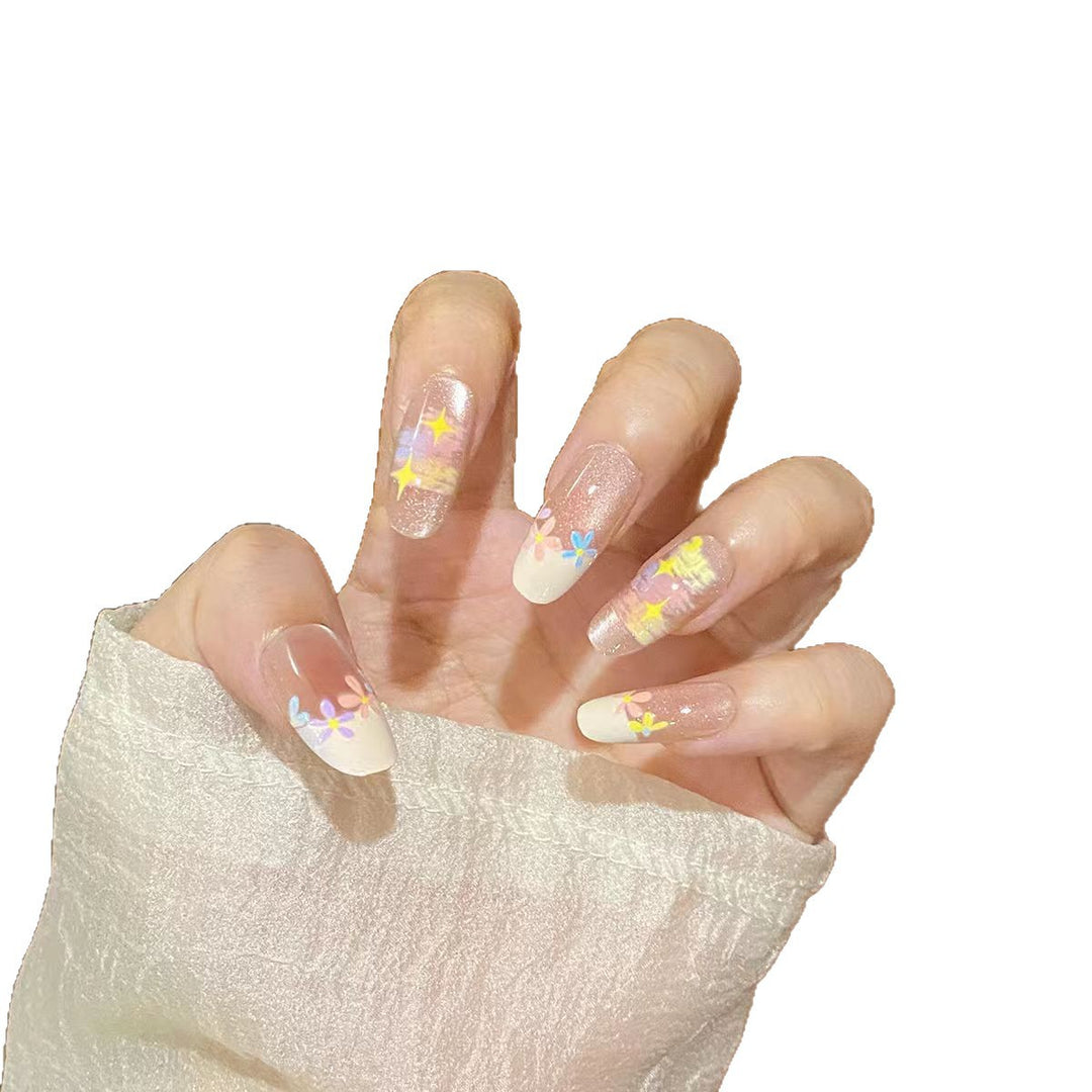 Artificial nails with delicate floral accents and glitter effects Stornfield