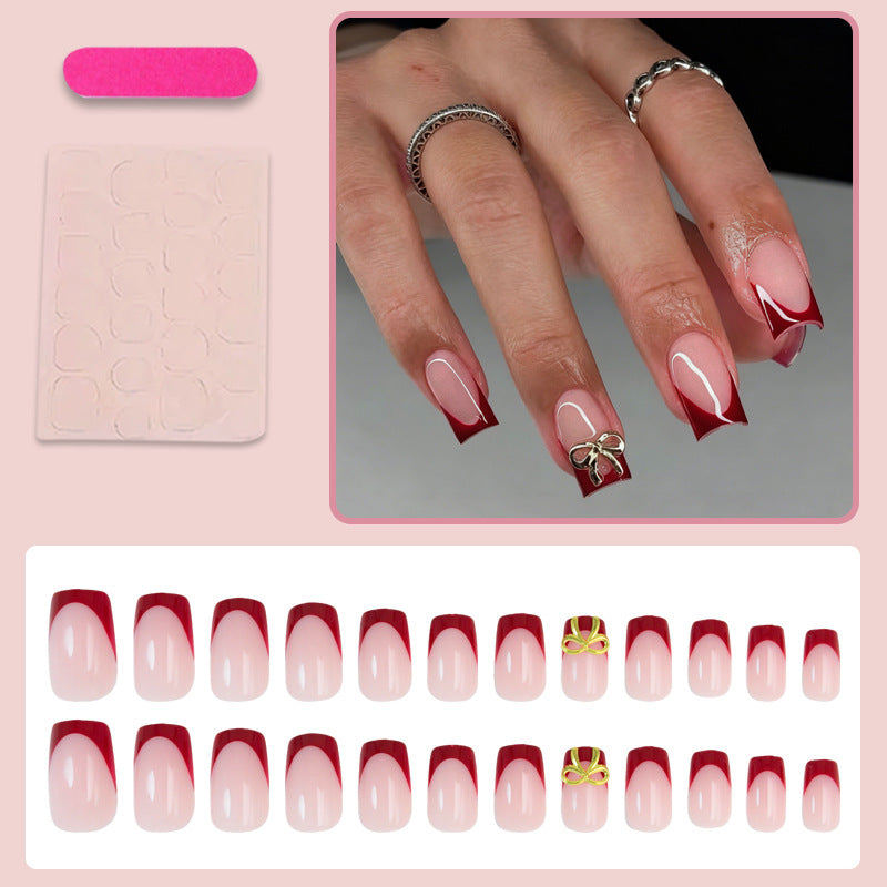 Artificial nail set with elegant red tips and refined bow decorations Stornfield