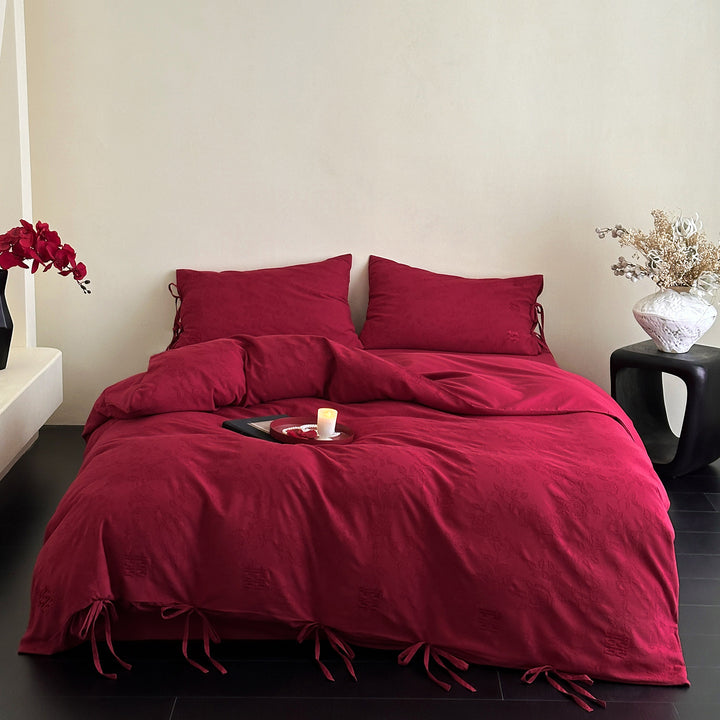 Luxurious cotton satin bedding set with decorative ribbons and jacquard texture