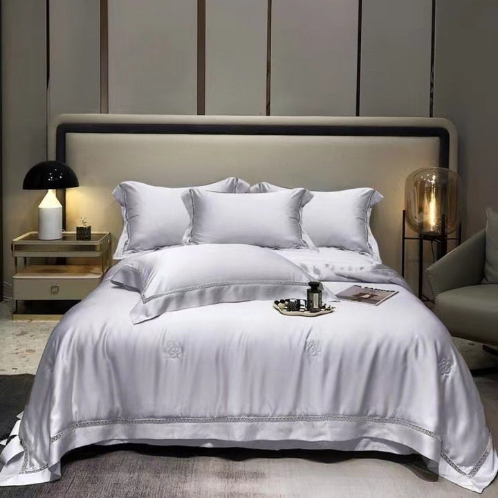 Luxurious satin bedding set with fine embroidered border and tone-on-tone floral relief