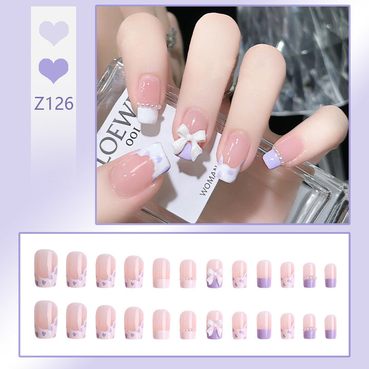 Nail art set with elegant wave patterns and delicate pearl accents Stornfield