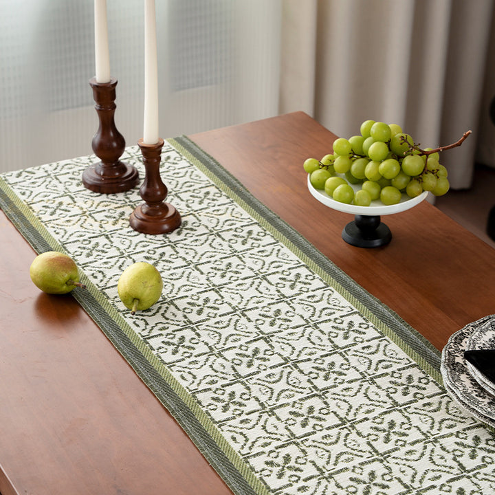 Decorative table runner with woven ornament jacquard and finely hemmed edges Stornfield