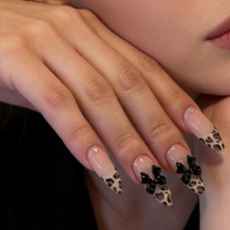 Artificial nail tips with elegant leopard pattern and bow decoration Stornfield