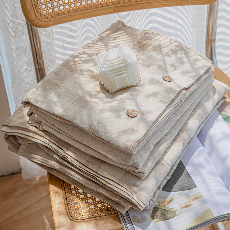 Reversible linen look duvet cover with large check pattern and wooden button closure