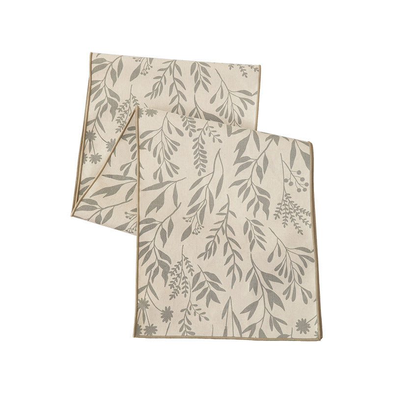 Woven table runner in botanical leaf pattern made of cotton blend Stornfield