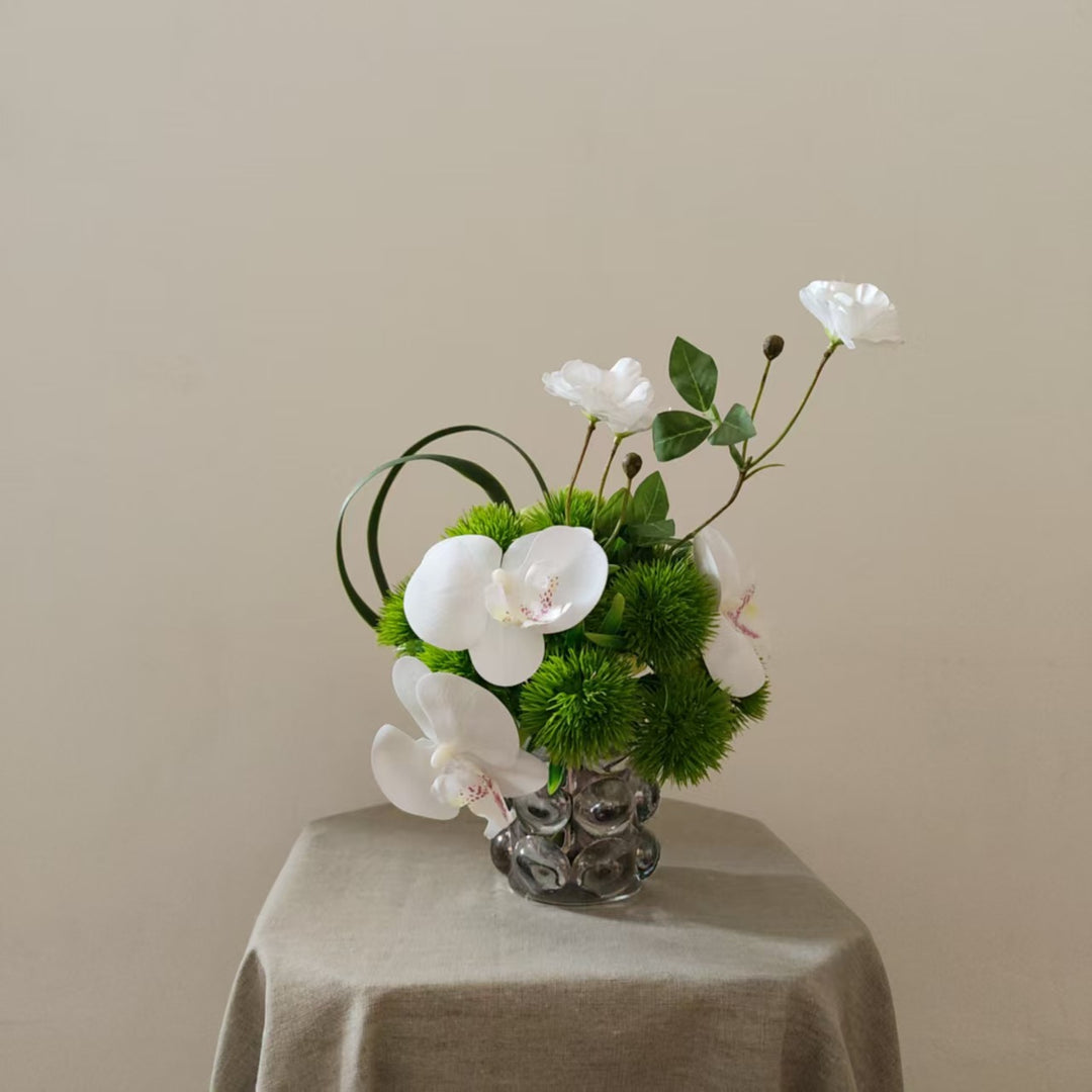 Lifelike Orchid and Greenery Floral Arrangement